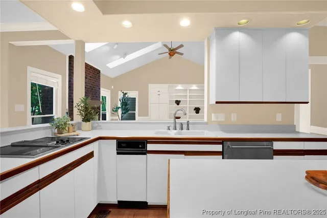 a kitchen with a sink and chairs