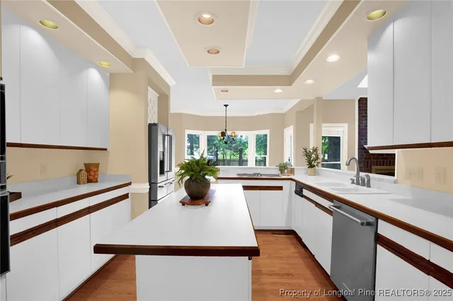 a large white kitchen with a large window