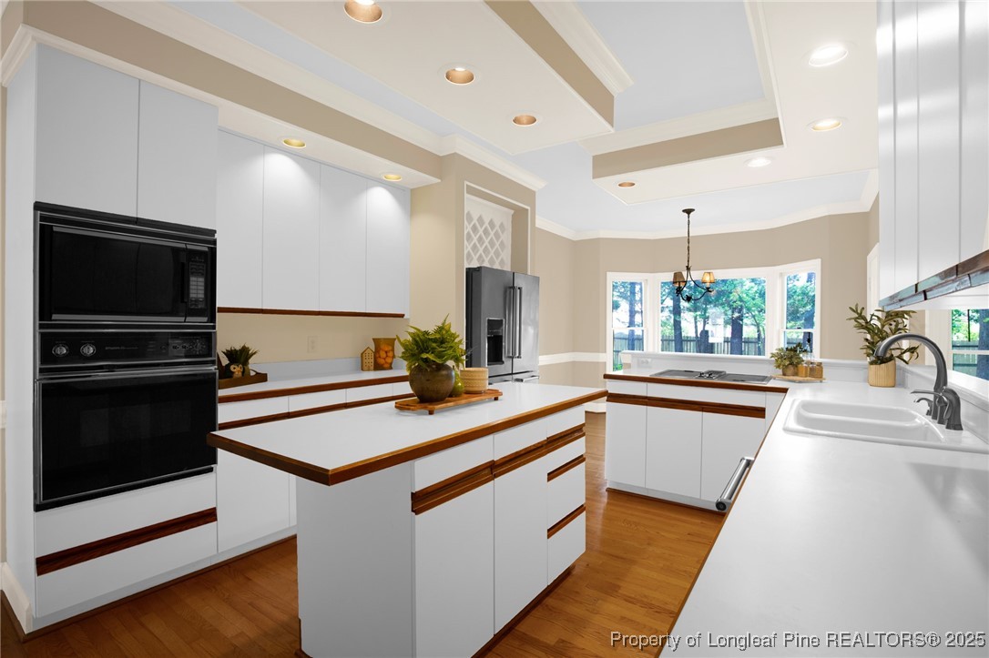 453 Kingsford Road Fayetteville, NC 28314 - Photo 22 of 50 a kitchen with stainless steel appliances kitchen island granite countertop a sink and a stove