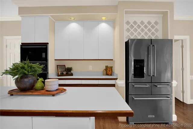 a kitchen with a refrigerator and a sink
