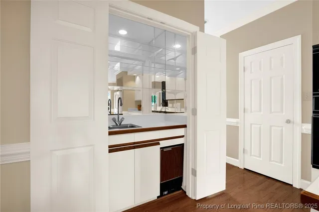 a kitchen with kitchen island sink and refrigerator