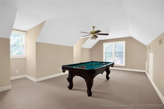 a room with pool table and windows