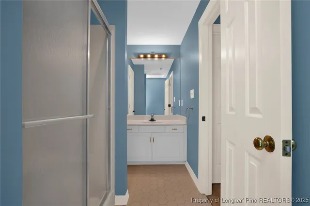 a bathroom with a tub sink and mirror