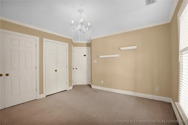 a view of a chandelier in big room and a chandelier