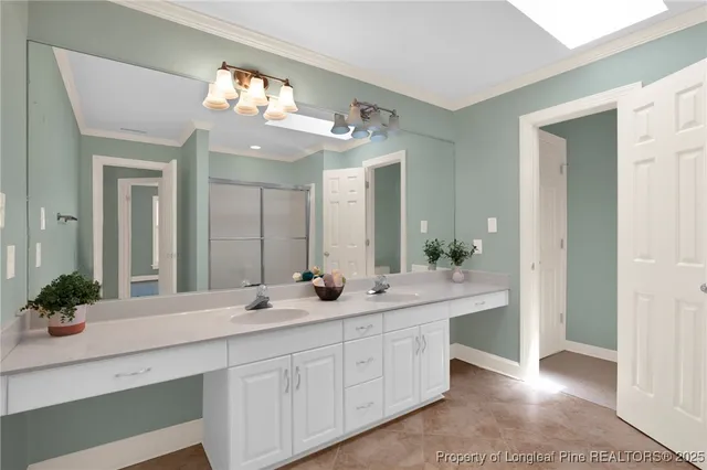 a bathroom with a sink double vanity and a mirror