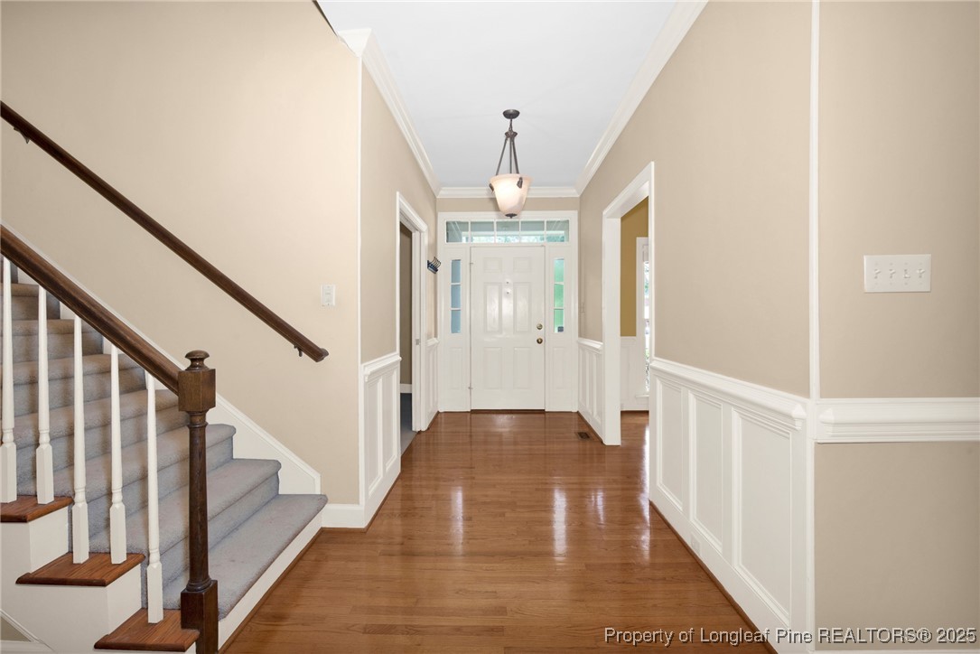 453 Kingsford Road Fayetteville, NC 28314 - Photo 4 of 50 a view of a hallway with wooden floor and staircase