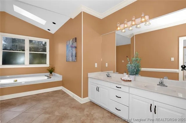 a spacious bathroom with a granite countertop sink a large mirror and a bathtub