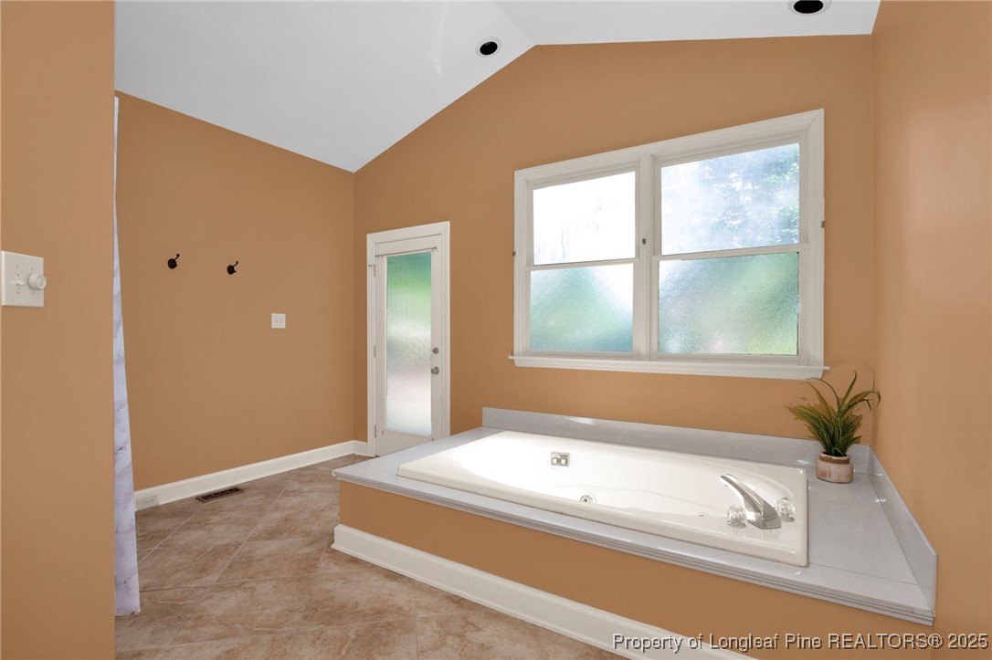 453 Kingsford Road Fayetteville, NC 28314 - Photo 10 of 50 a bathroom with a tub sink and mirror