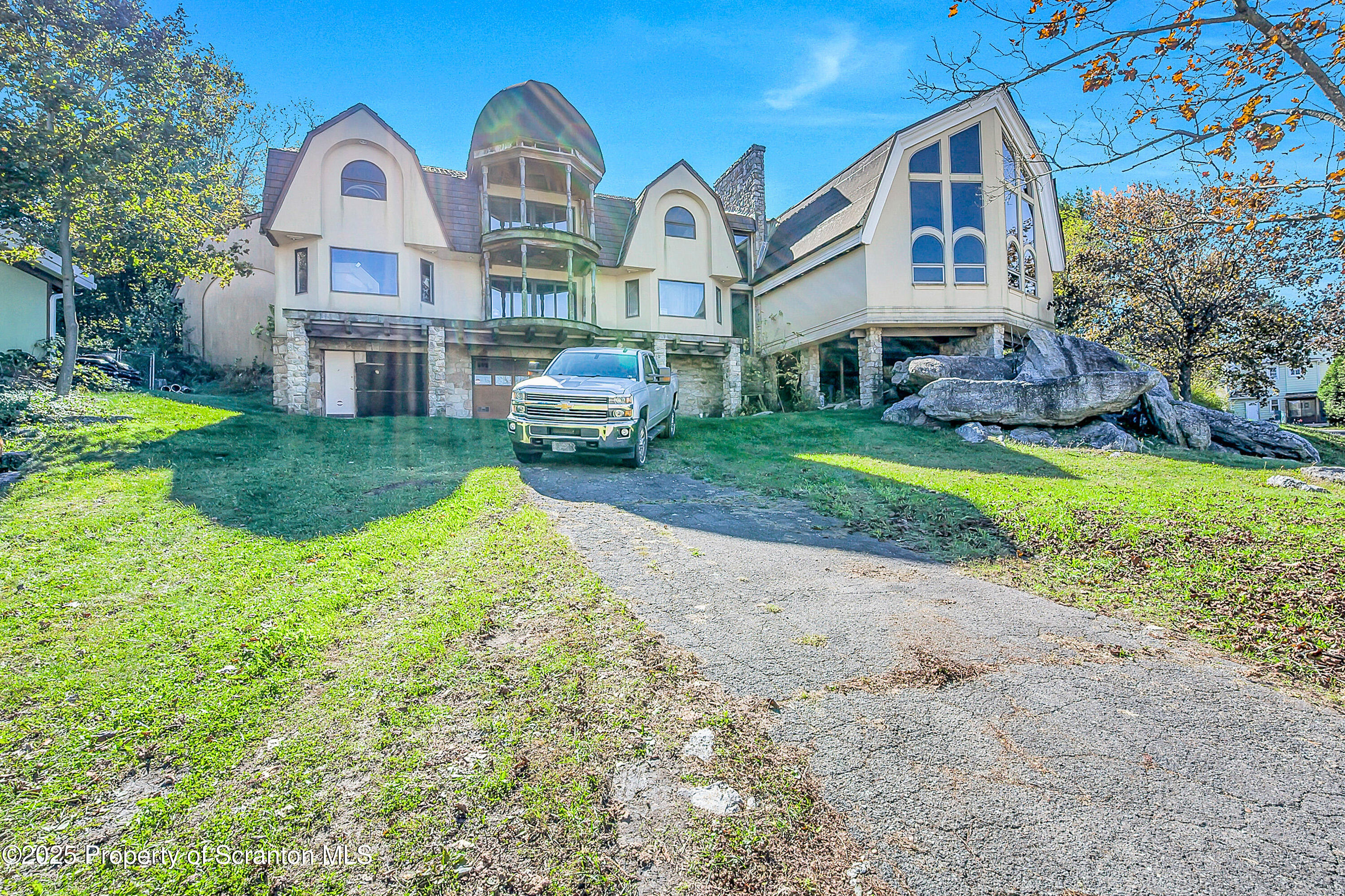 a front view of house with yard and green space