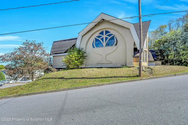 a view of house with yard and entertaining space