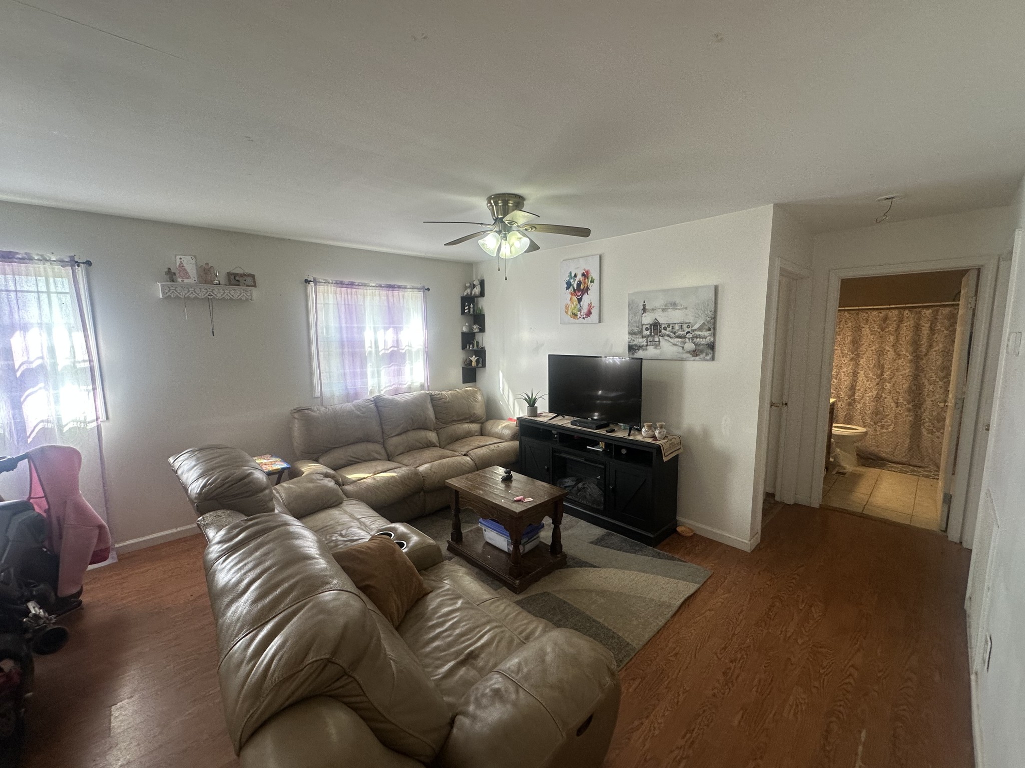 104 Clifton Road Lawrenceburg, TN 38464 - Photo 10 of 14 a living room with furniture a window and a flat screen tv
