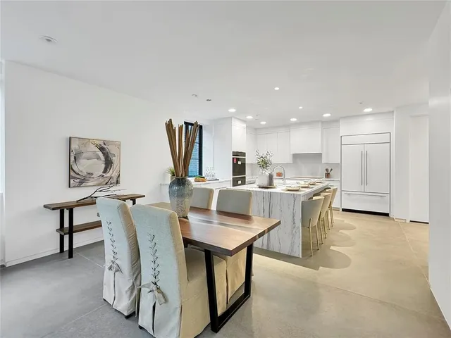 a dining room with furniture and a kitchen view