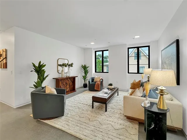 a living room with furniture and a potted plant
