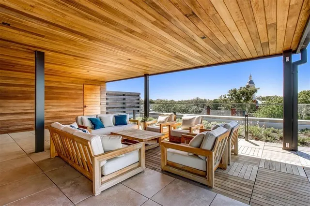 a balcony with furniture and wooden floor