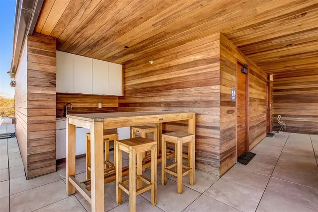 a view of a patio with a table and chairs