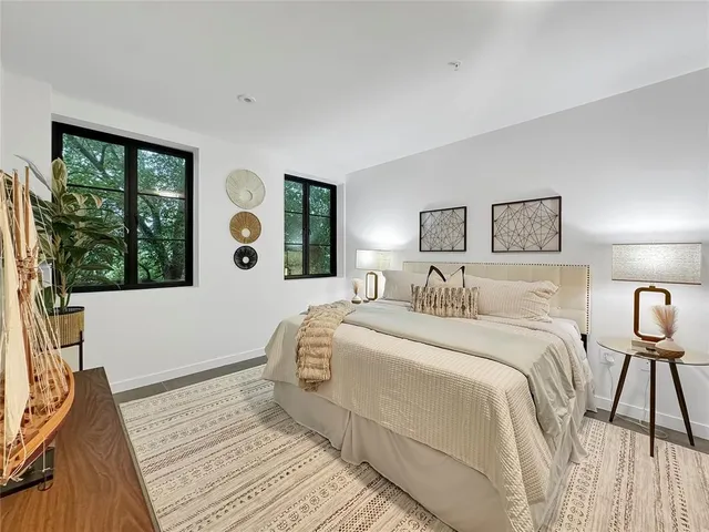 a spacious bedroom with a large bed and a large window