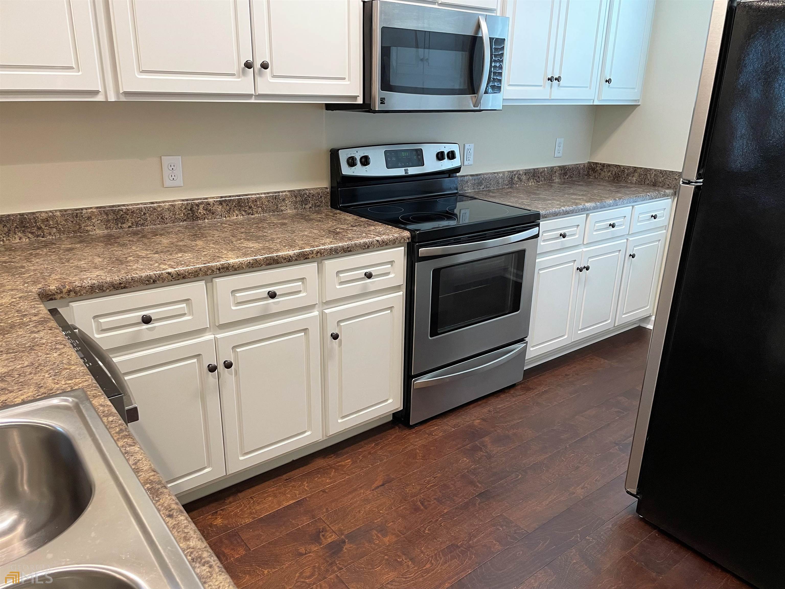 148 Buckhaven Way, Unit 148 Statesboro, GA 30458 - Photo 13 of 27 a kitchen with granite countertop white cabinets and stainless steel appliances