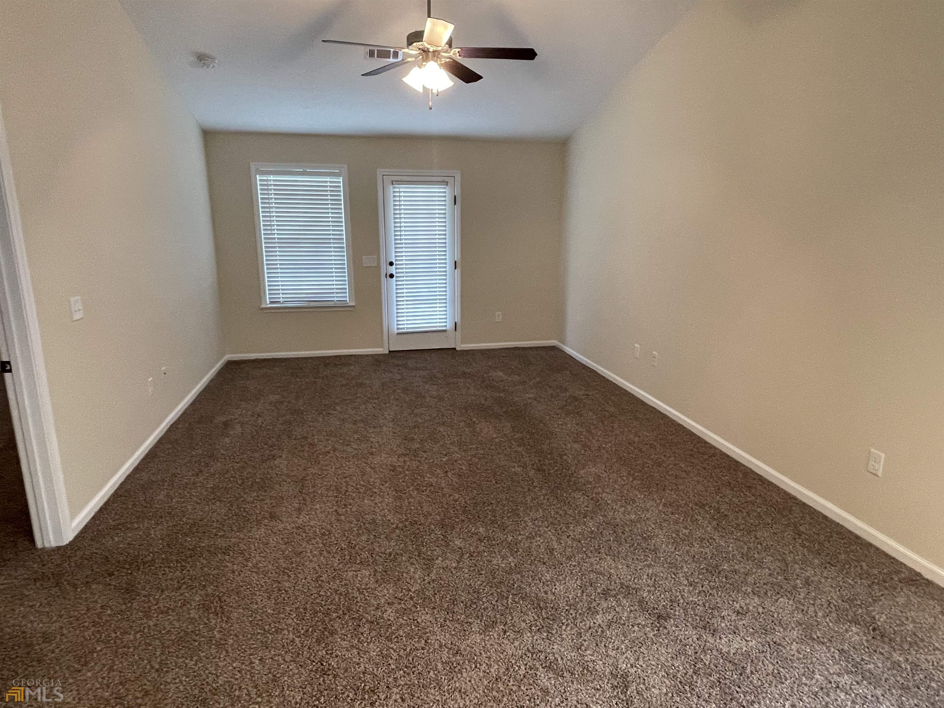 148 Buckhaven Way, Unit 148 Statesboro, GA 30458 - Photo 20 of 27 an empty room with windows and chandelier fan