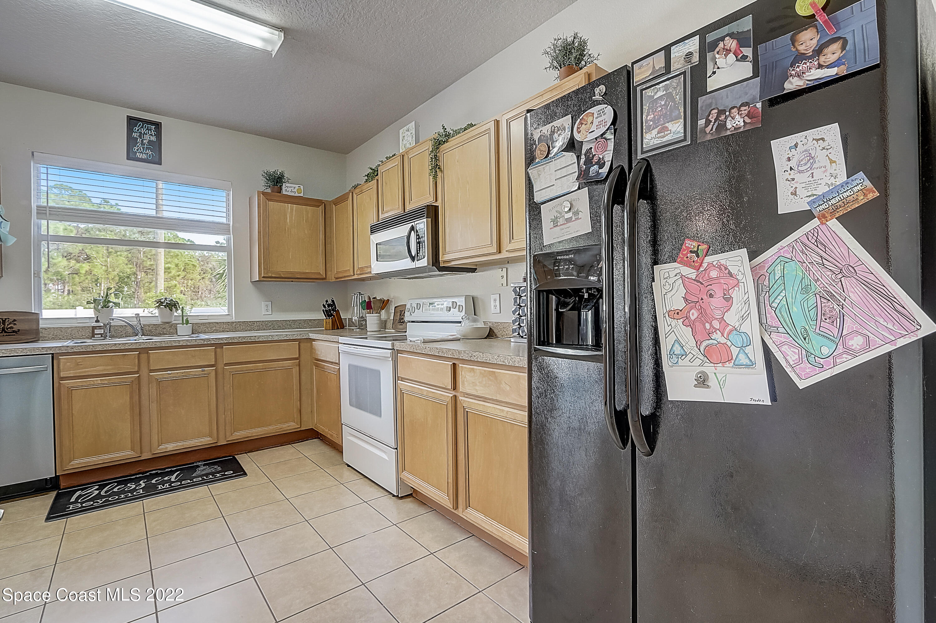 3687 Mt Carmel Lane Melbourne, FL 32901 - Photo 15 of 46 a kitchen with stainless steel appliances cabinets and a window