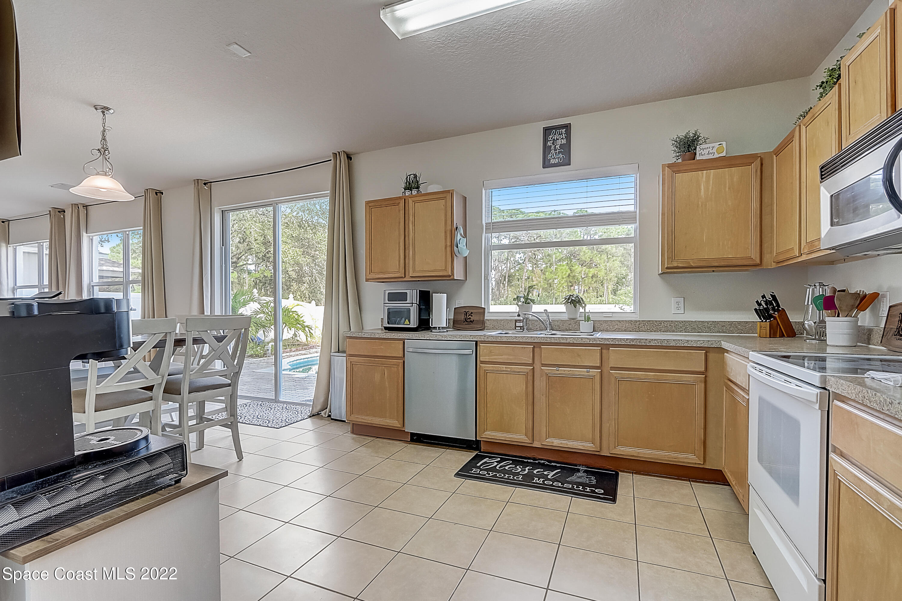 3687 Mt Carmel Lane Melbourne, FL 32901 - Photo 16 of 46 a kitchen with a sink cabinets and window