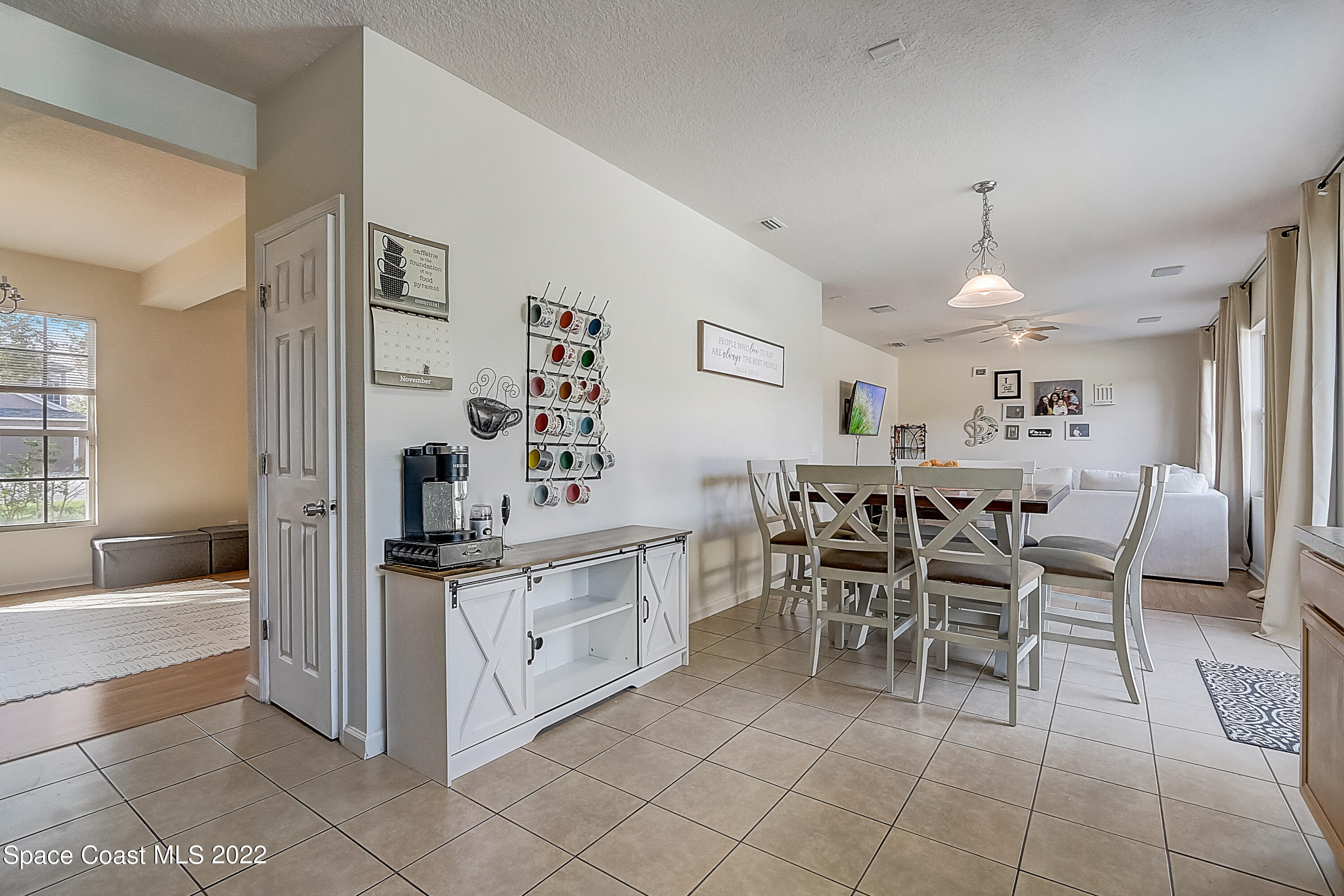 3687 Mt Carmel Lane Melbourne, FL 32901 - Photo 17 of 46 a large white kitchen with cabinets and chairs
