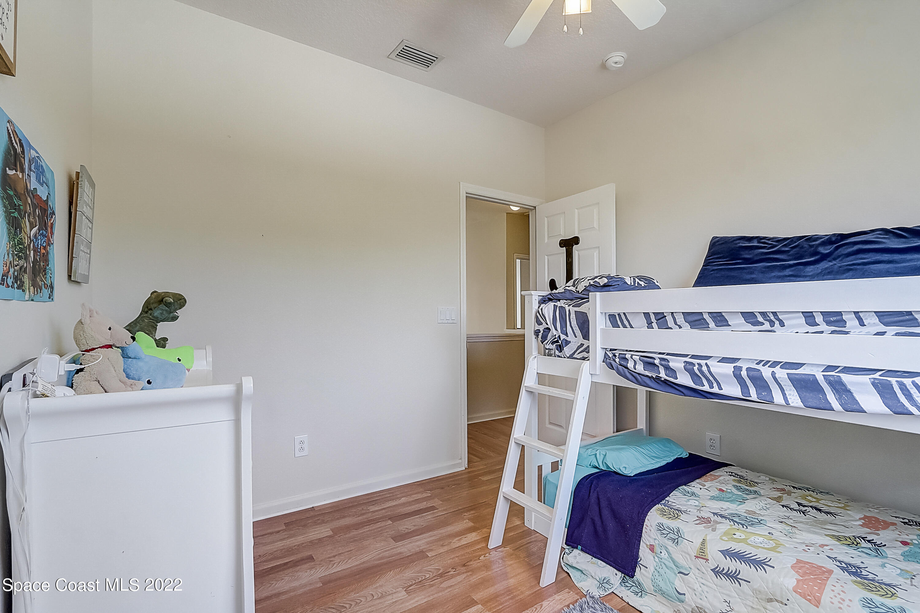 3687 Mt Carmel Lane Melbourne, FL 32901 - Photo 25 of 46 a bedroom with a bed and a chandelier