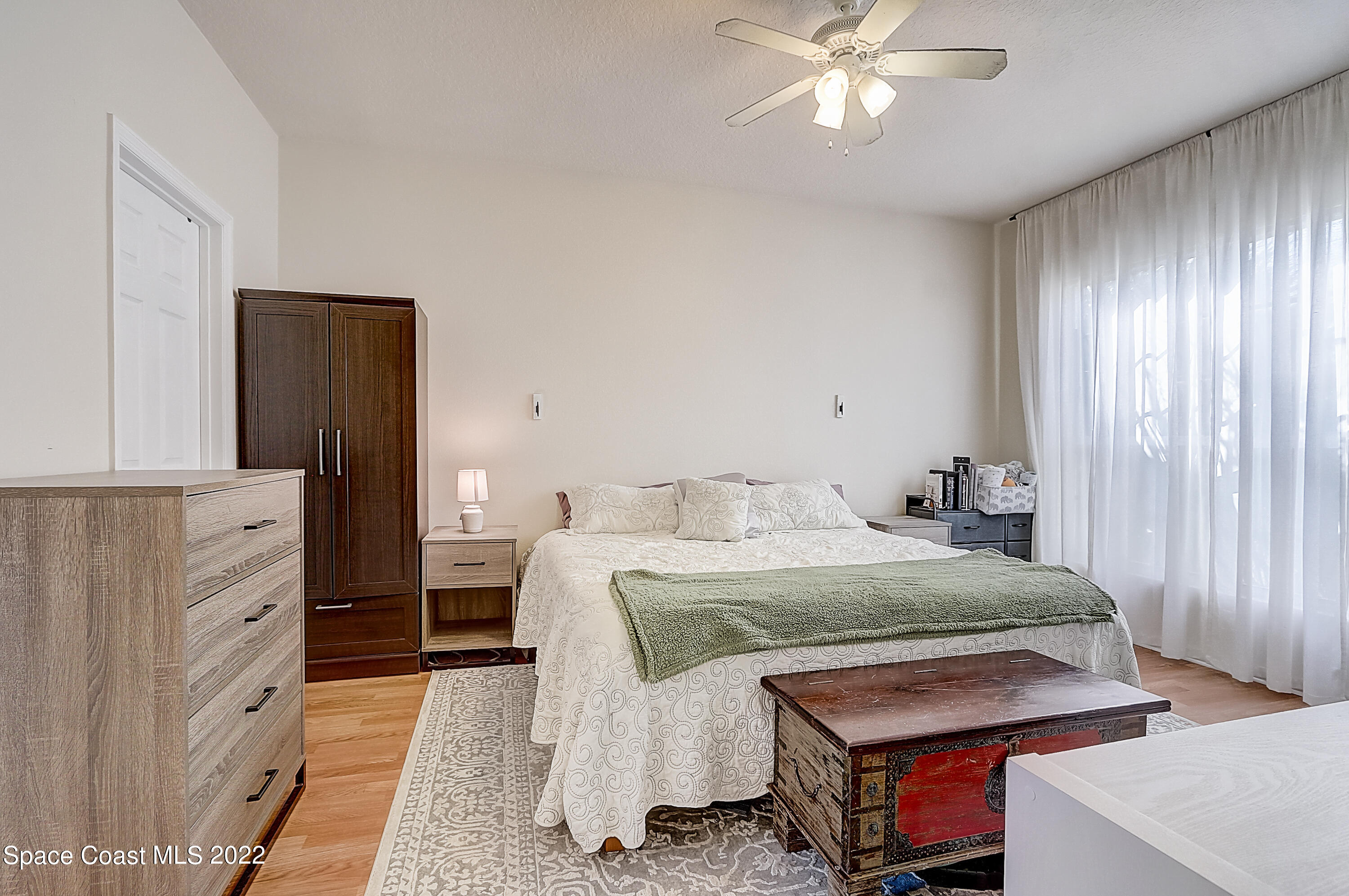 3687 Mt Carmel Lane Melbourne, FL 32901 - Photo 27 of 46 a bedroom with a bed and a dresser