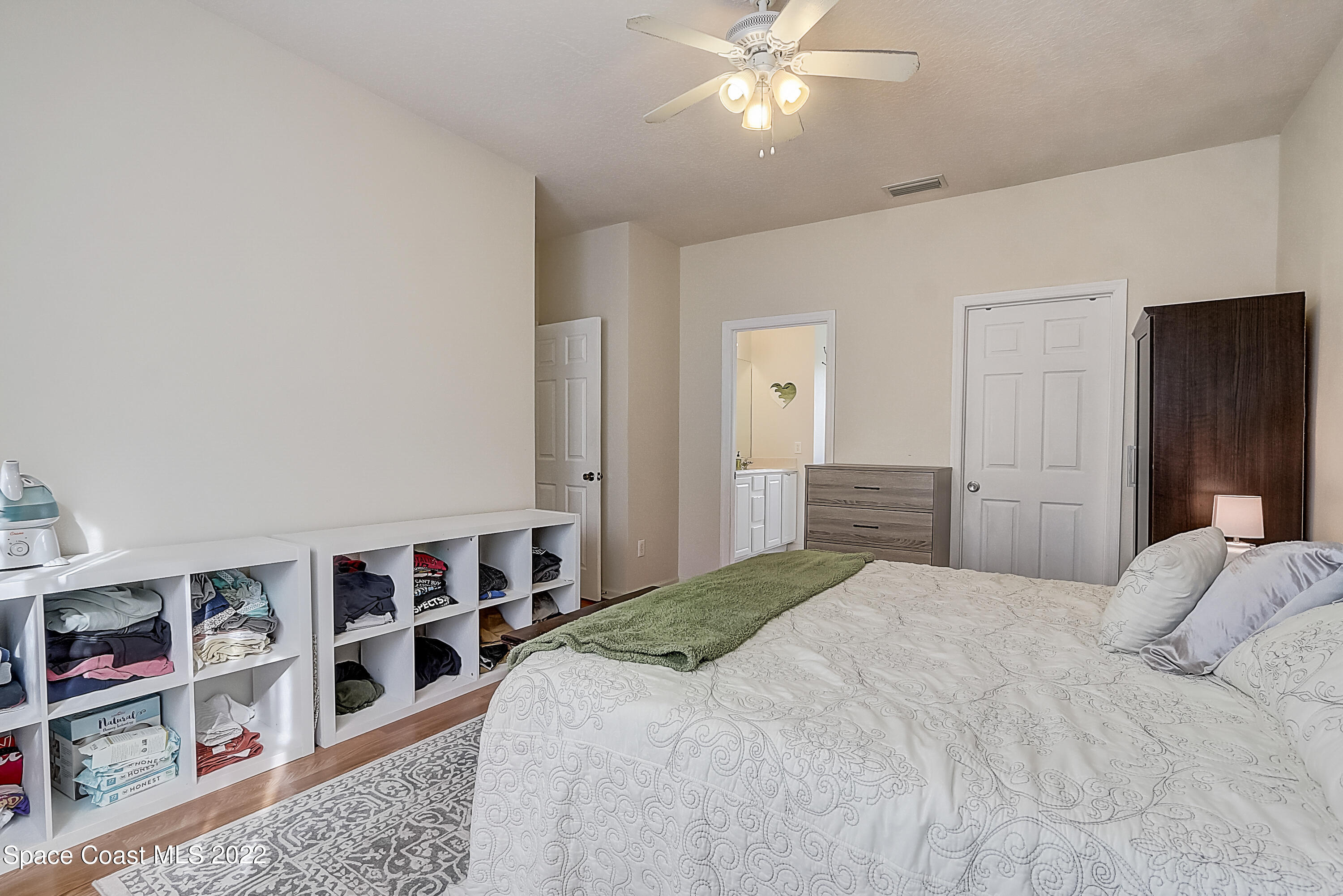 3687 Mt Carmel Lane Melbourne, FL 32901 - Photo 28 of 46 a bedroom with a bed and a book shelf