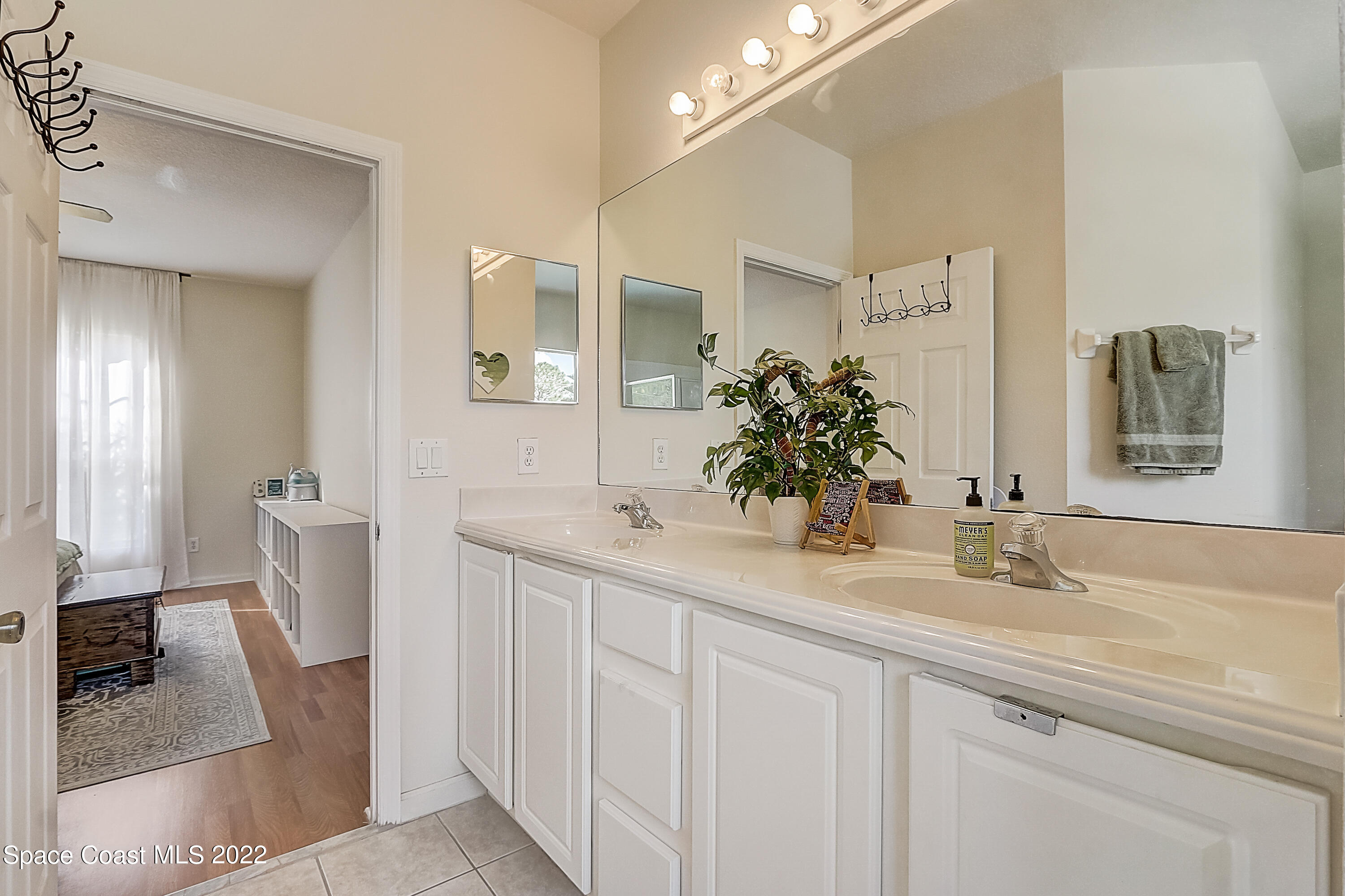 3687 Mt Carmel Lane Melbourne, FL 32901 - Photo 31 of 46 a bathroom with a sink and a mirror