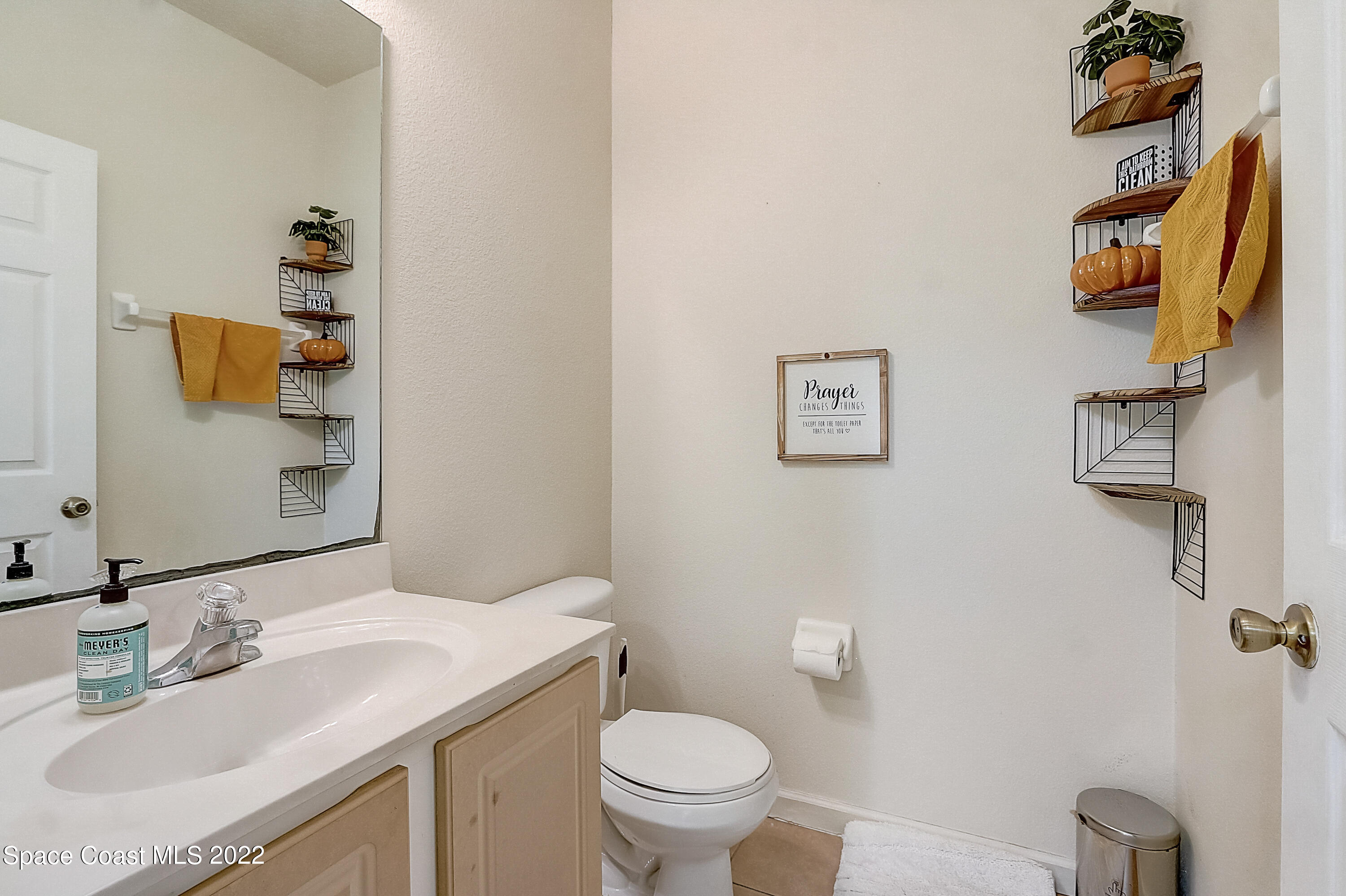 3687 Mt Carmel Lane Melbourne, FL 32901 - Photo 36 of 46 a bathroom with a granite countertop sink mirror vanity and toilet