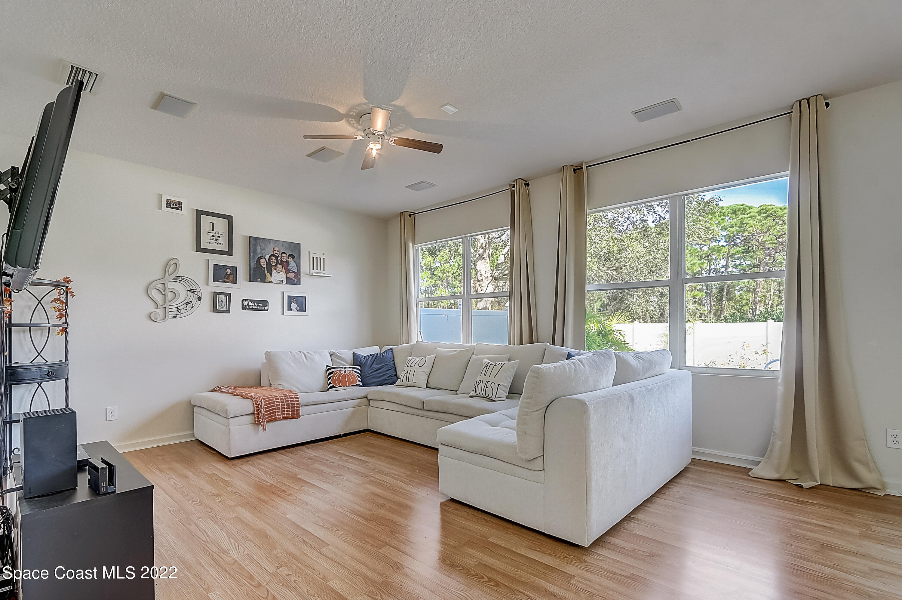 3687 Mt Carmel Lane Melbourne, FL 32901 - Photo 37 of 46 a living room with furniture and a large window