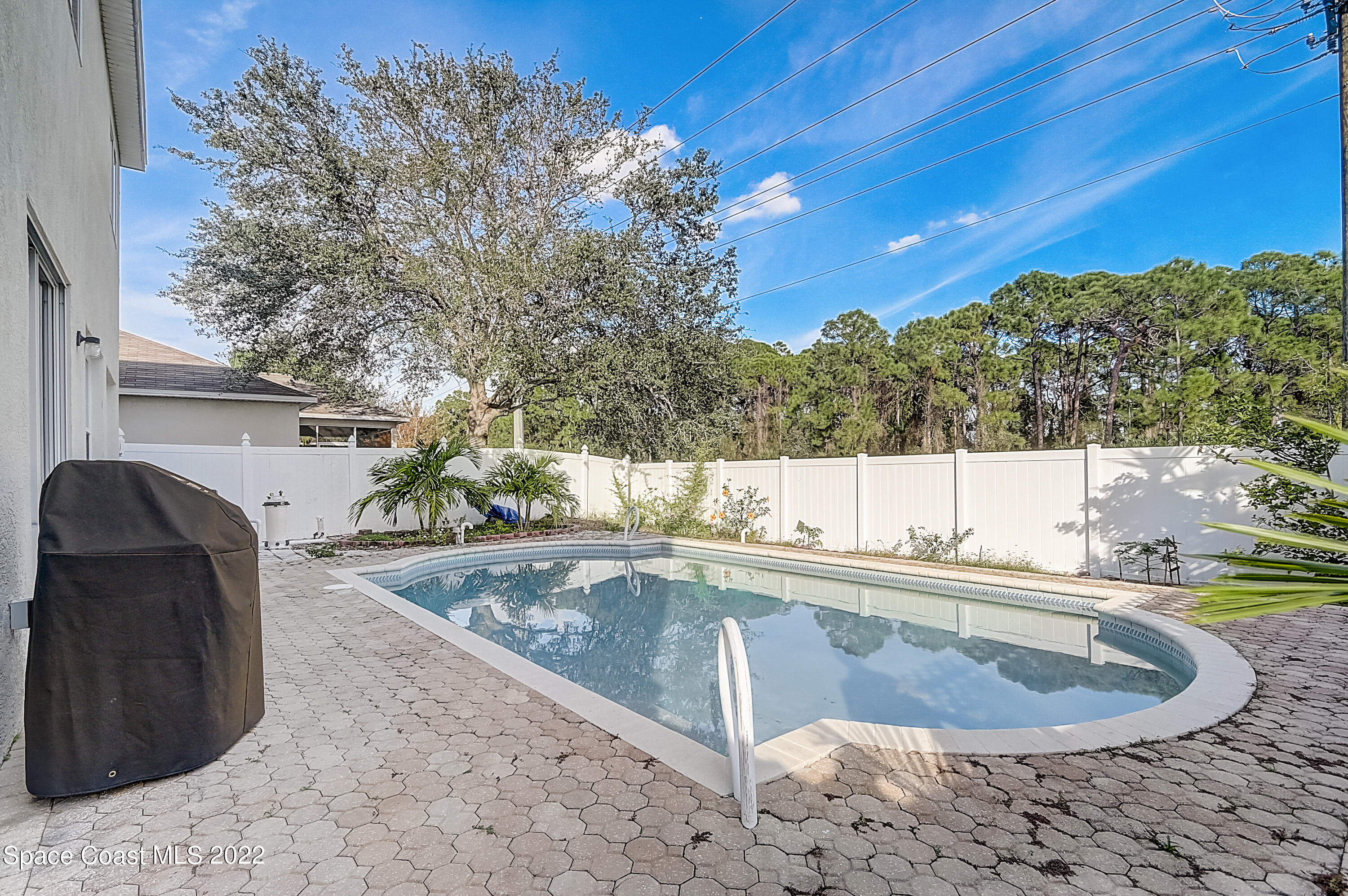 3687 Mt Carmel Lane Melbourne, FL 32901 - Photo 38 of 46 a view of a swimming pool with a sitting space