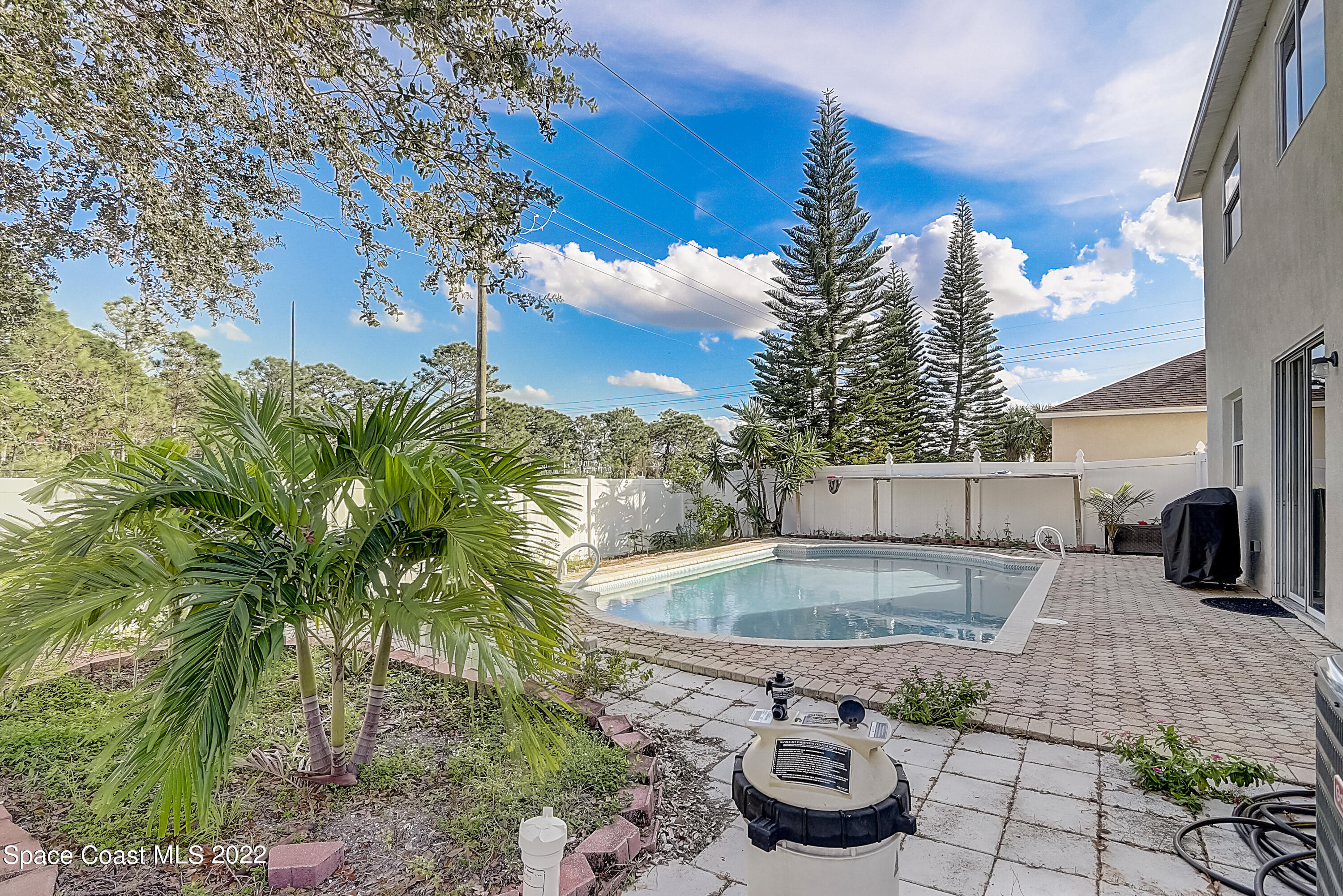 3687 Mt Carmel Lane Melbourne, FL 32901 - Photo 44 of 46 a view of a swimming pool with a patio