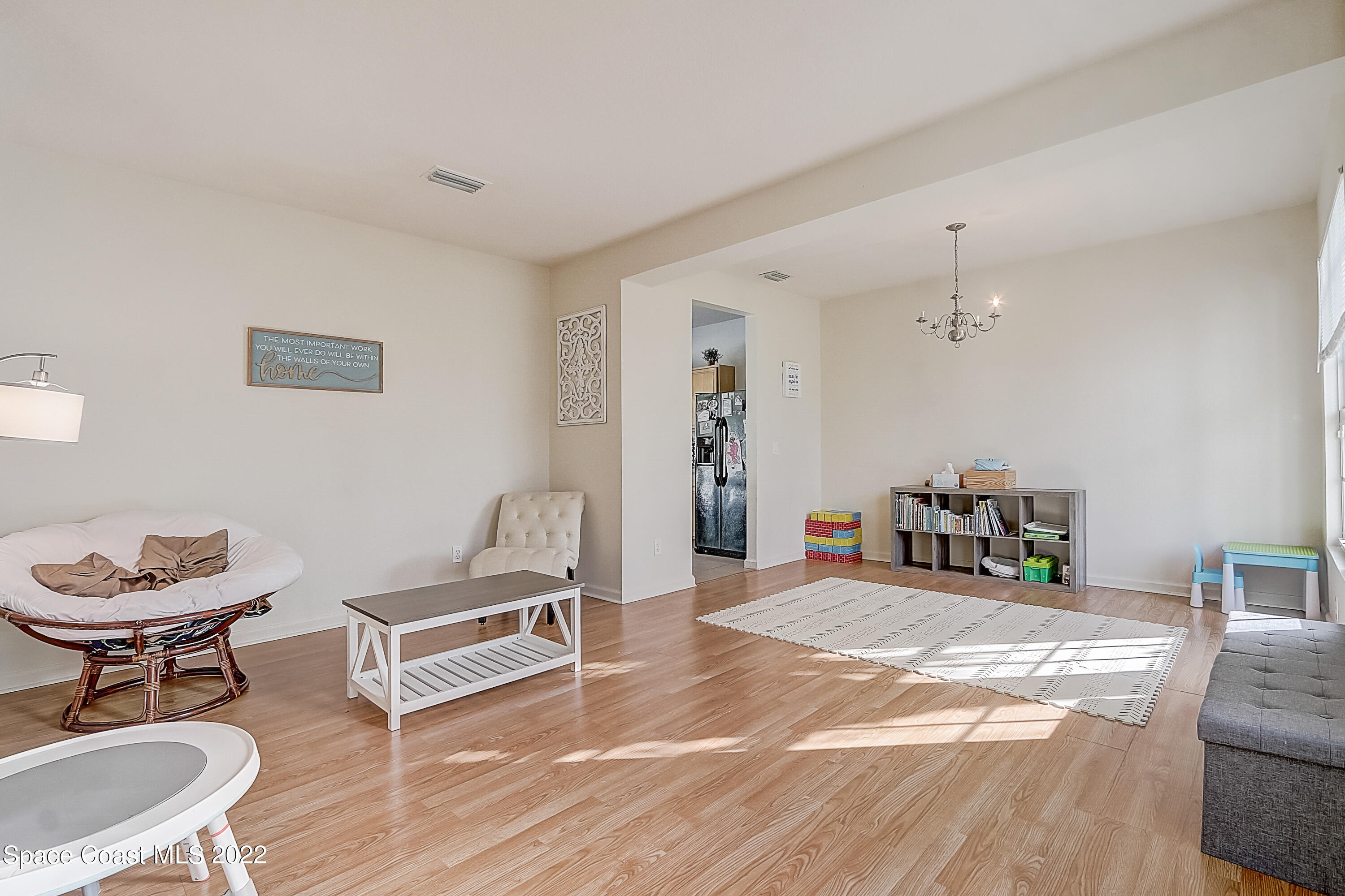 3687 Mt Carmel Lane Melbourne, FL 32901 - Photo 5 of 46 a living room with furniture and a chair