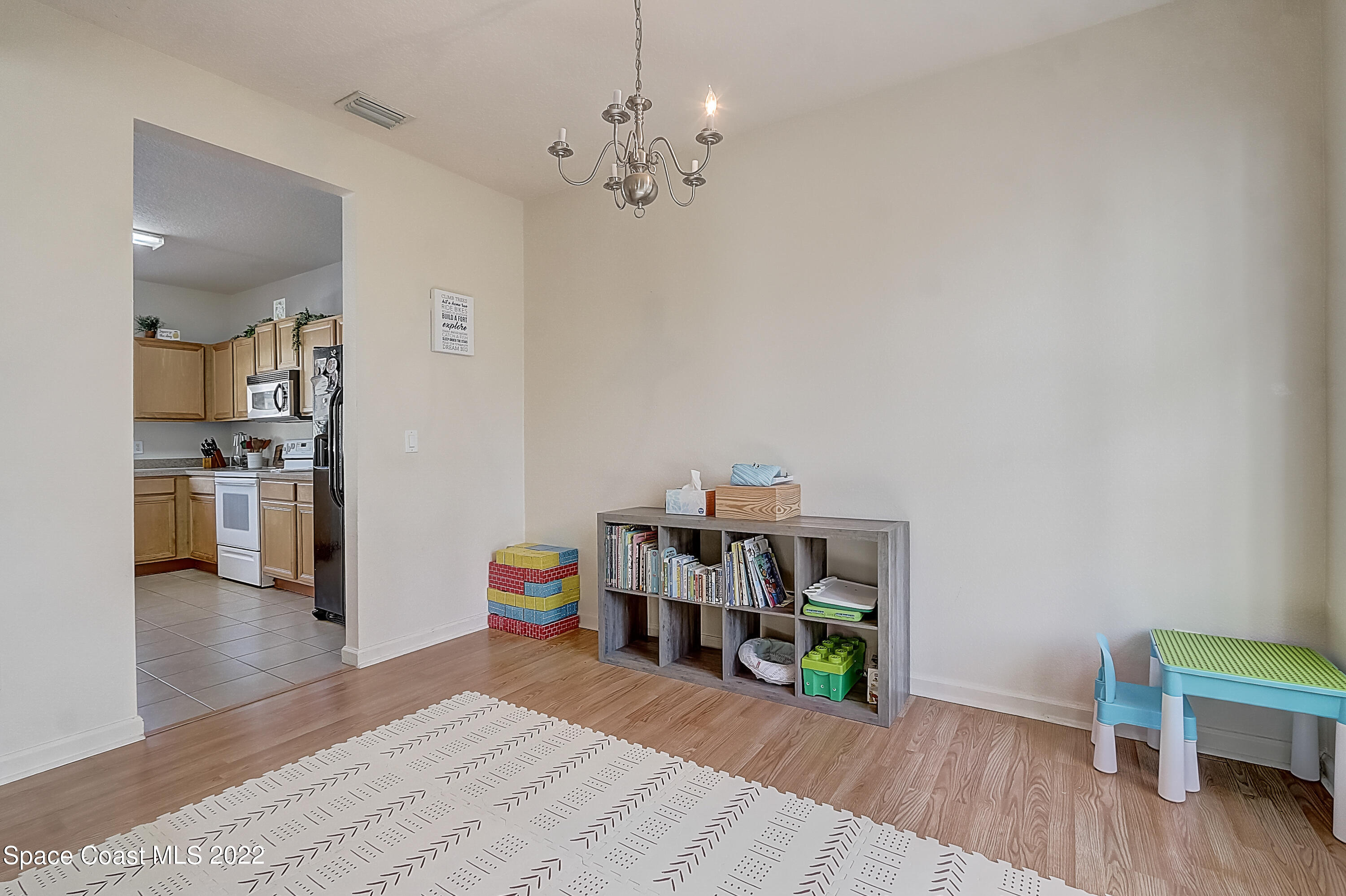3687 Mt Carmel Lane Melbourne, FL 32901 - Photo 7 of 46 a view of a workspace with furniture and wooden floor