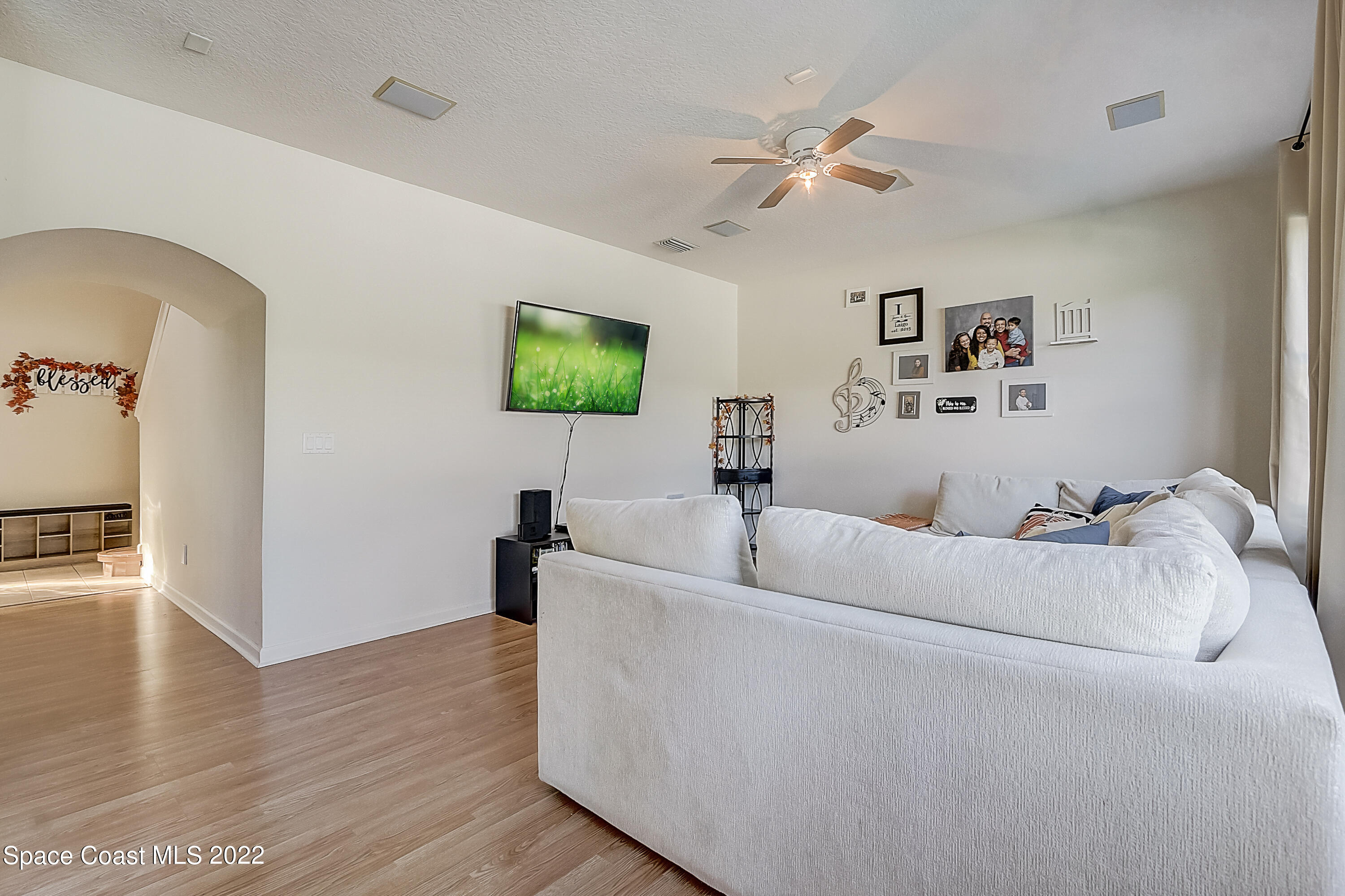 3687 Mt Carmel Lane Melbourne, FL 32901 - Photo 10 of 46 a living room with furniture and a flat screen tv
