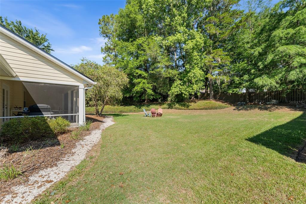7418 White Oaks Road Alachua, FL 32615 - Photo 40 of 46 a view of white house with a yard and large trees