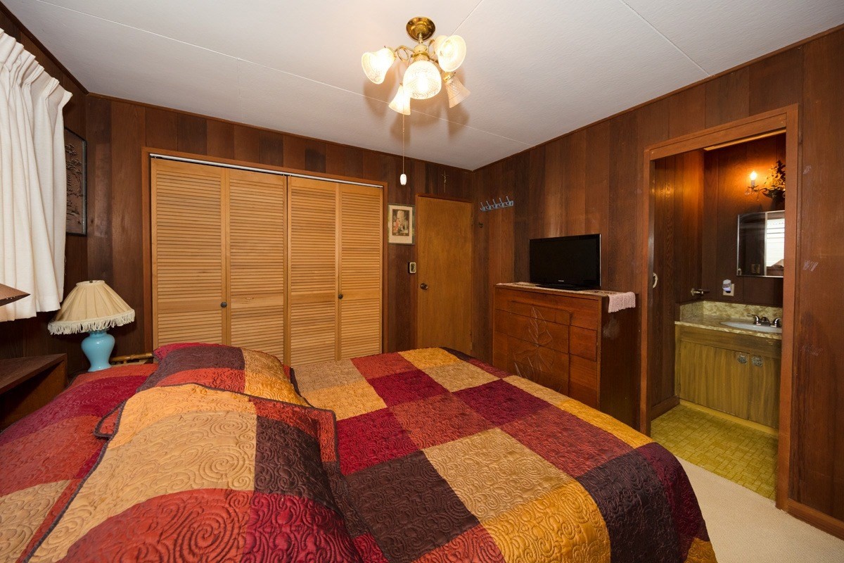 25 Kaapuni Loop Hilo, HI 96720 - Photo 17 of 25 a bedroom with a bed and a chandelier