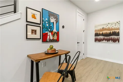 a view of a workspace with furniture and wooden floor