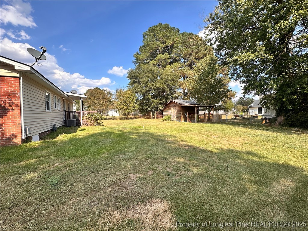 1109 Strickland Bridge Road Fayetteville, NC 28304 - Photo 18 of 20 a view of outdoor space with garden and trees
