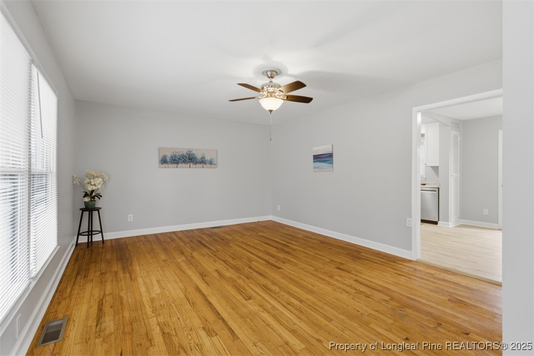 1109 Strickland Bridge Road Fayetteville, NC 28304 - Photo 4 of 20 wooden floor in an empty room with a window