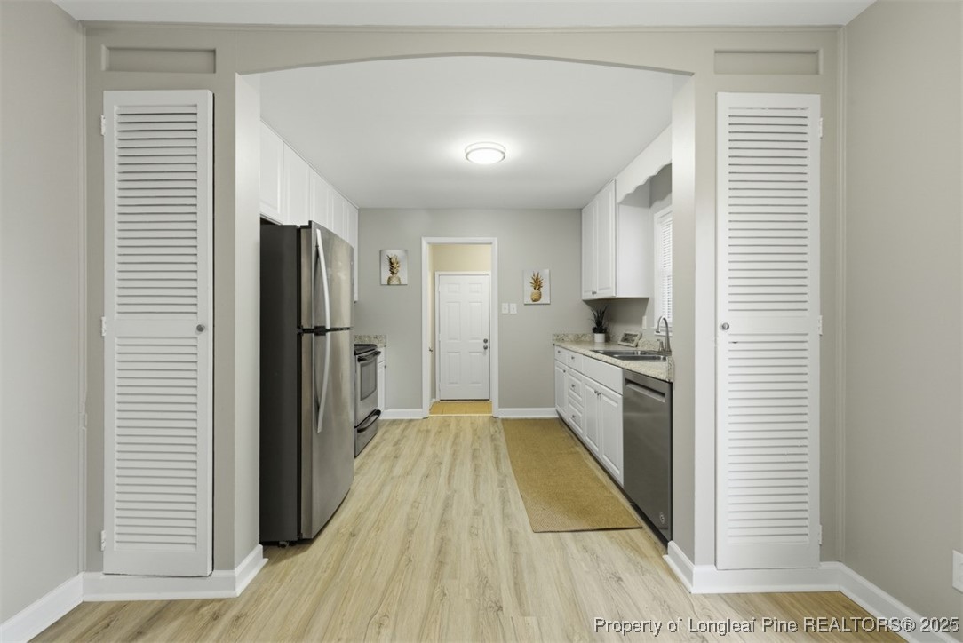 1109 Strickland Bridge Road Fayetteville, NC 28304 - Photo 6 of 20 a kitchen with a refrigerator an oven and sink