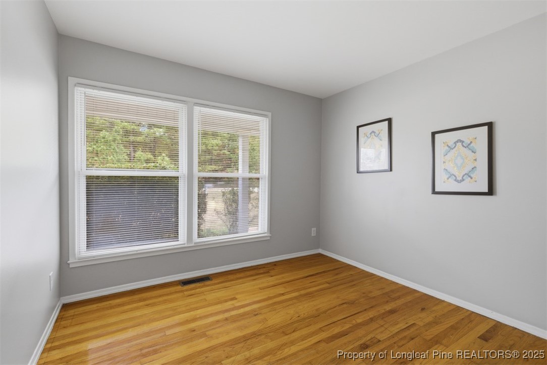 1109 Strickland Bridge Road Fayetteville, NC 28304 - Photo 8 of 20 a view of empty room with wooden floor and fan