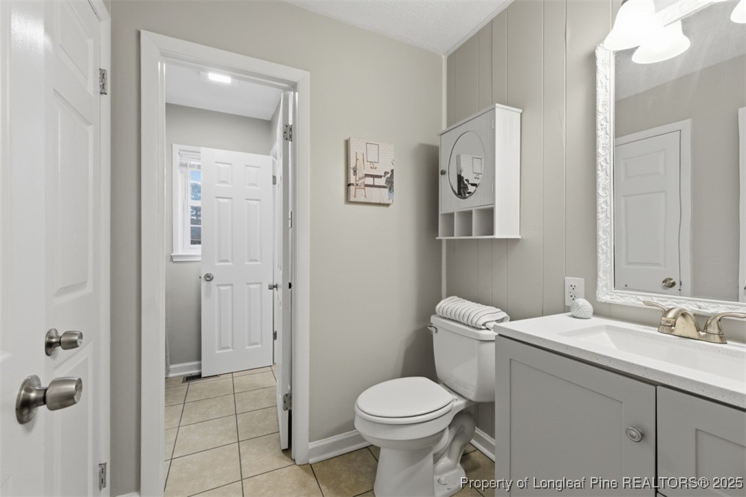 1109 Strickland Bridge Road Fayetteville, NC 28304 - Photo 9 of 20 a bathroom with a toilet sink and mirror