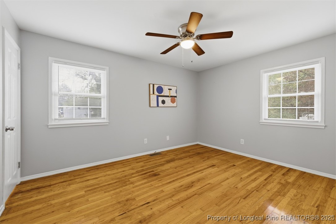 1109 Strickland Bridge Road Fayetteville, NC 28304 - Photo 10 of 20 a view of a big room with wooden floor and windows