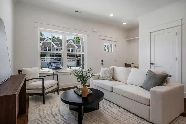 a living room with furniture and a large window