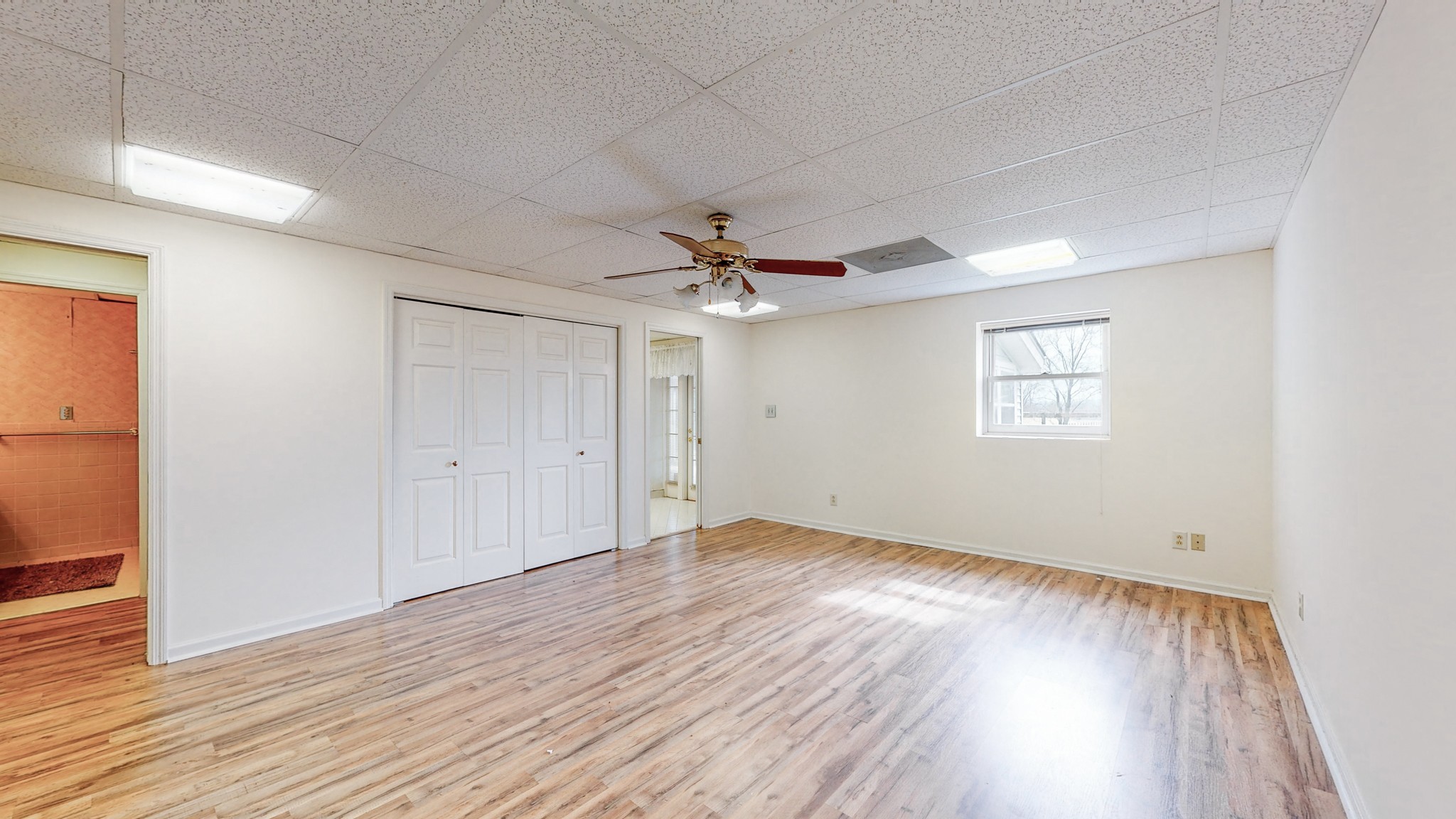 2165 Palmer Road Lebanon, TN 37090 - Photo 37 of 67 an empty room with wooden floor chandelier fan and windows