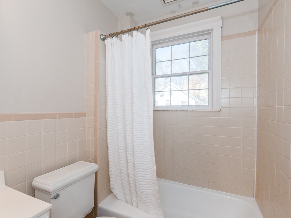 9 Cornauba Street Boston, MA 02131 - Photo 16 of 21 a white toilet sitting next to a bath tub