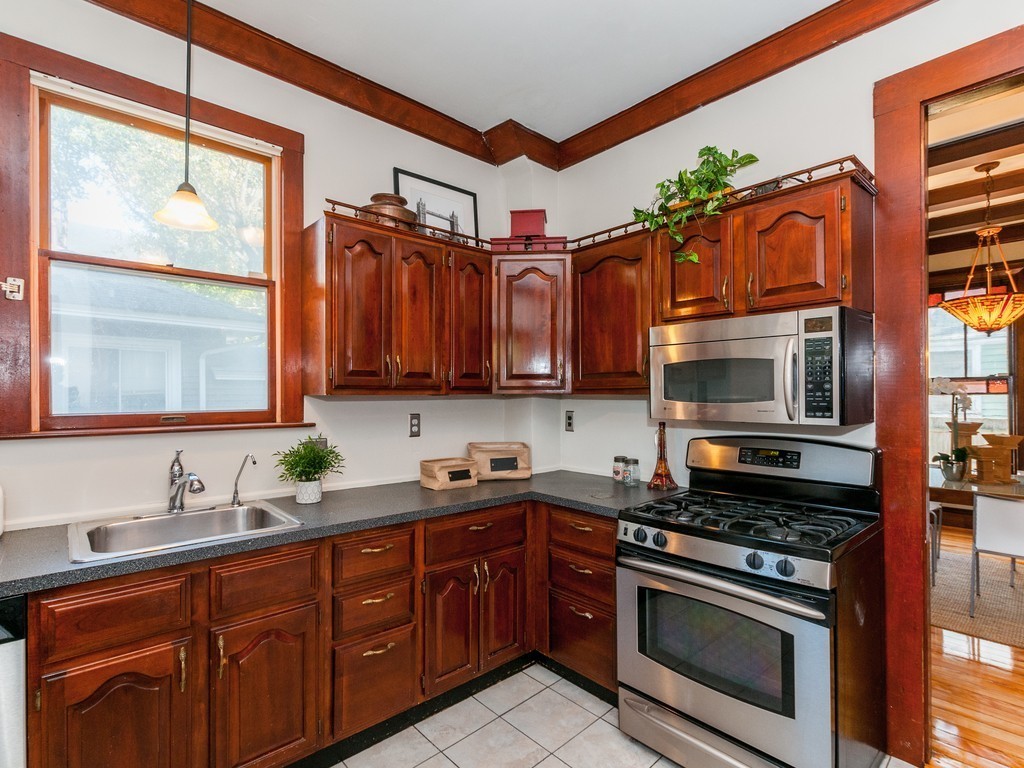 9 Cornauba Street Boston, MA 02131 - Photo 8 of 21 a kitchen with stainless steel appliances granite countertop a stove a sink and a microwave