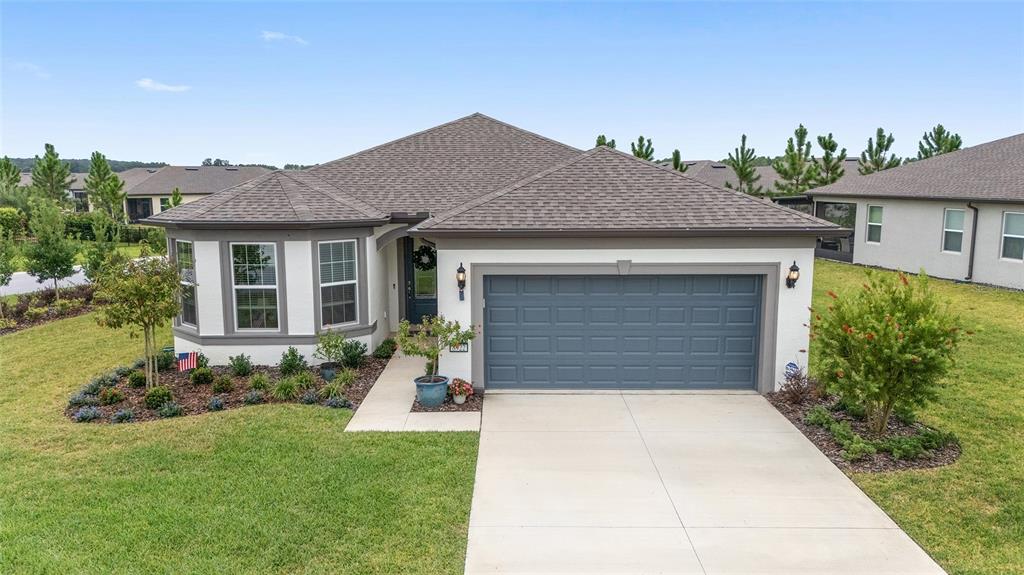 8922 Southwest 58th Street Road Ocala, FL 34481 - Photo 1 of 1 a front view of a house with a yard